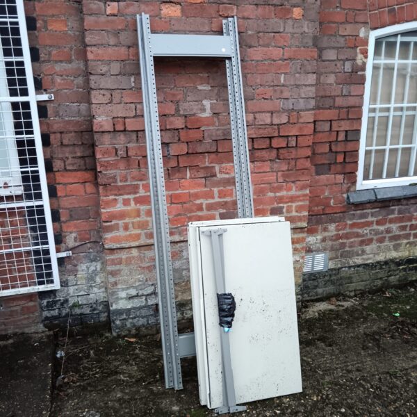 Side view of a metal racking unit with adjustable shelf supports.