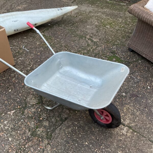 Used metal wheelbarrow for garden and landscaping tasks.