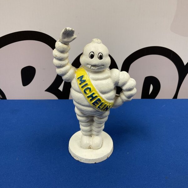 Vintage cast iron Michelin Man figure, classic advertising collectible.