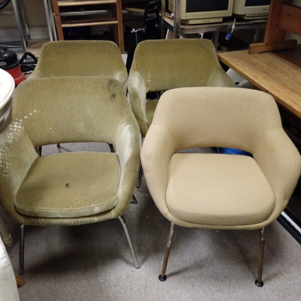 Vintage green mid-century modern chairs with chrome legs awaiting restoration.