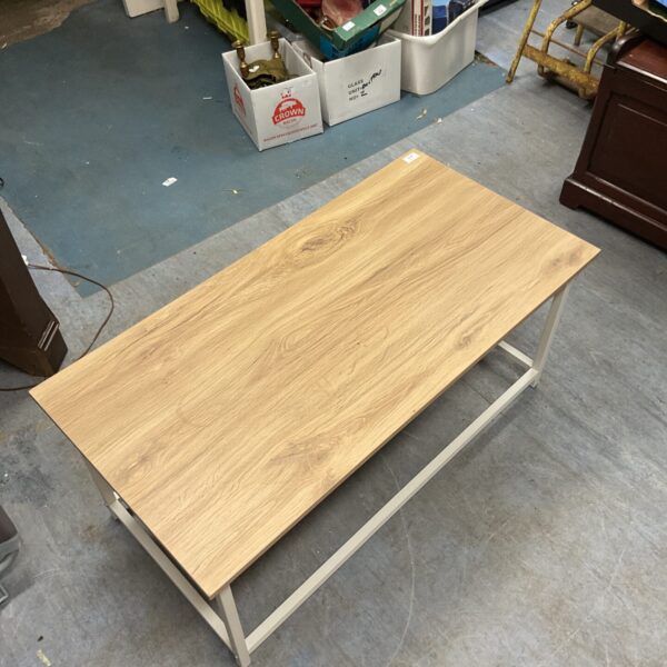 Light-toned wood mid-century modern coffee table in a living space.