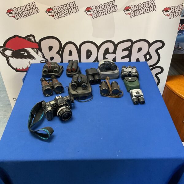 Vintage Minolta 7000 camera with binoculars in a lot.