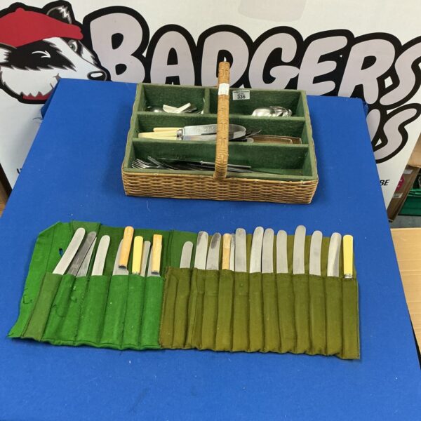 Vintage mixed cutlery tray with silver and stainless steel pieces.