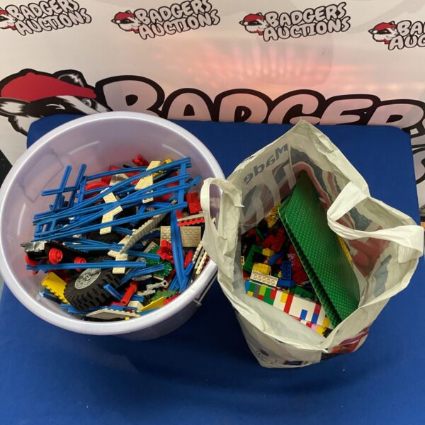 Mixed Lego lot in a plastic container with a bag.