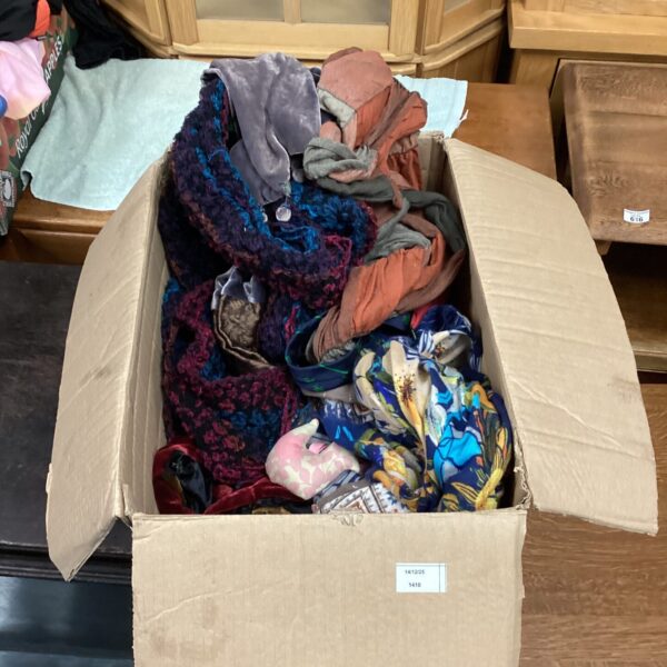 Mixed lot of colourful patterned and silk scarves for sale.