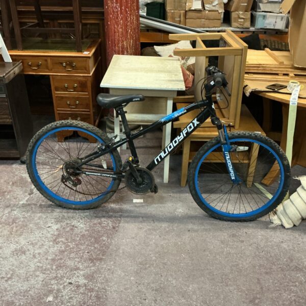 Side view of a Muddyfox Sniper mountain bike.