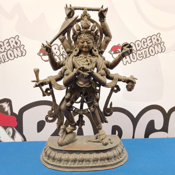 Antique Nepalese bronze Buddhist deity sculpture with multiple arms.