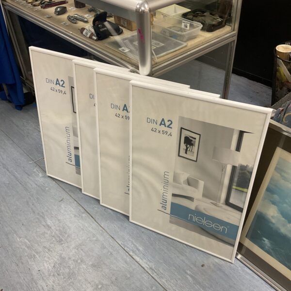Lot of four Nielsen aluminium picture frames measuring 42cm x 59.4cm.