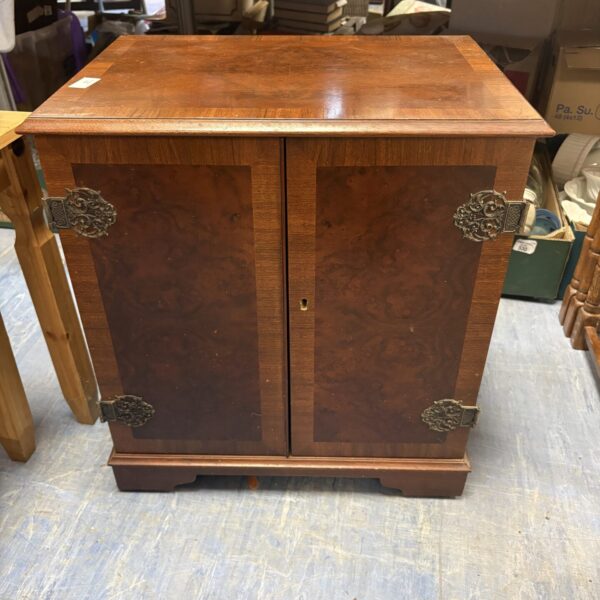 Front view of a brown oriental style media cabinet.
