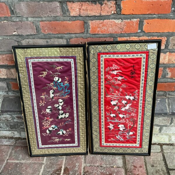 Vintage oriental silk tapestries featuring pandas and cranes.