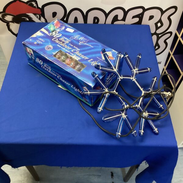 Coloured outdoor chaser lights with a large snowflake decoration.