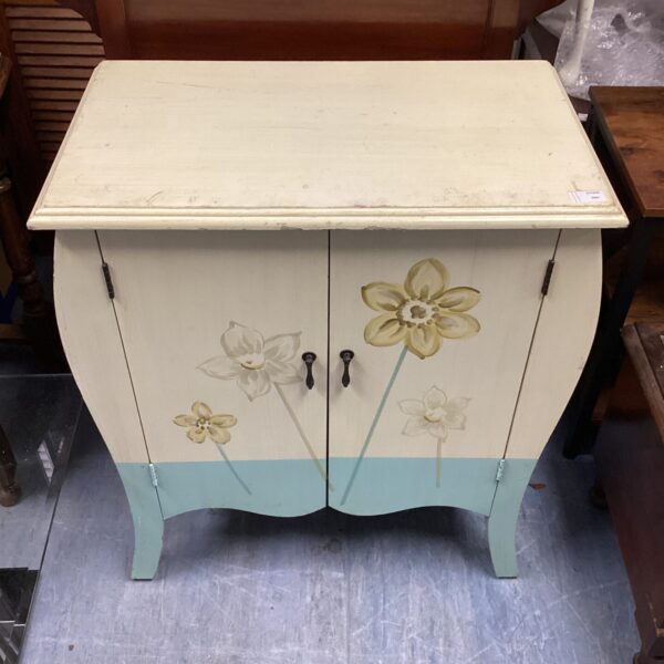 Front view of a small painted floral cabinet with vintage charm.