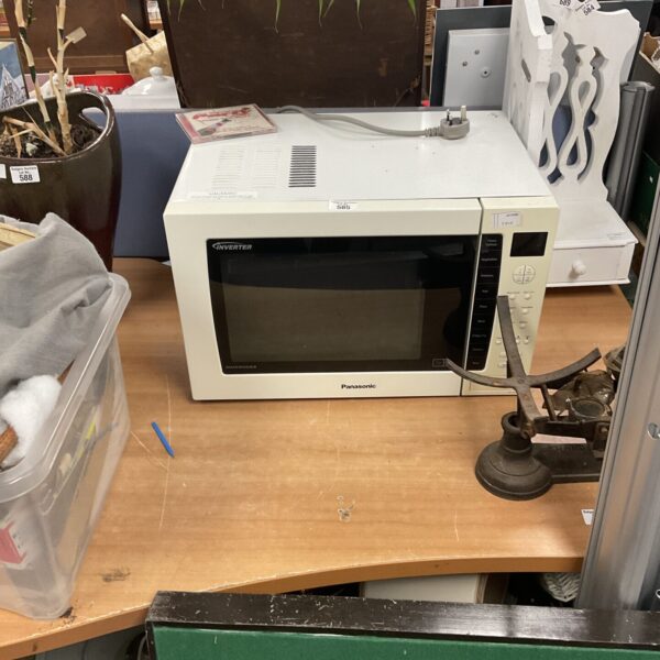 Front view of a silver Panasonic inverter microwave oven.