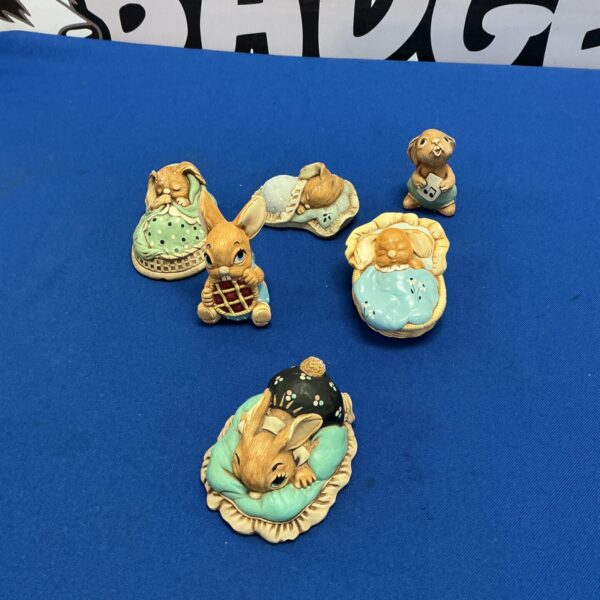 Six vintage Pendelfin rabbit figurines displayed together.