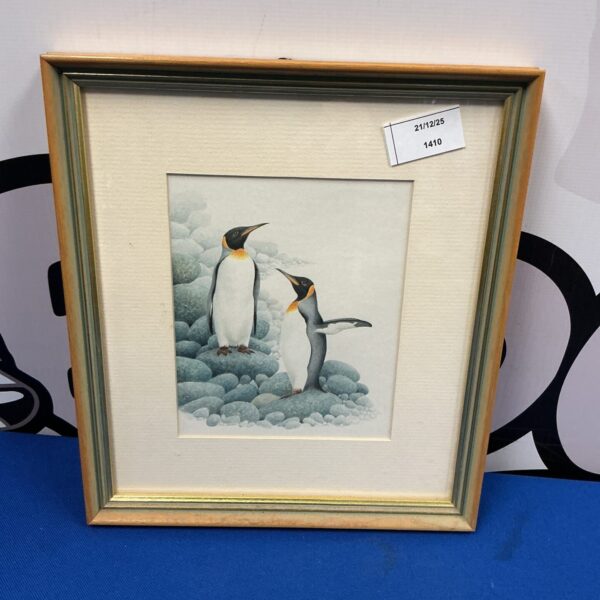 Framed watercolour painting of a pair of penguins.