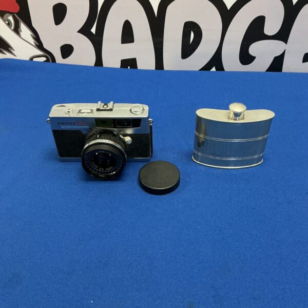 Vintage Petri 7s II camera with a flask.