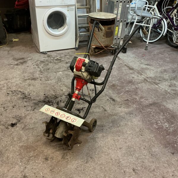 Used petrol cultivator for garden soil preparation.