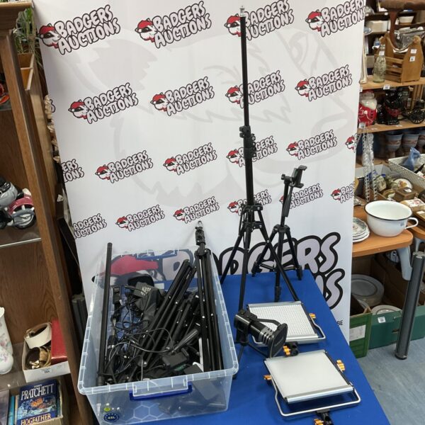 Collection of photography tripods and lights for studio use.
