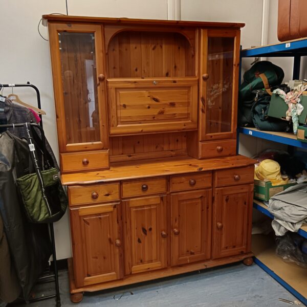 Front view of a vintage pine Welsh dresser with glass cabinets.