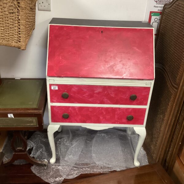 Front view of a pink vintage writing bureau.