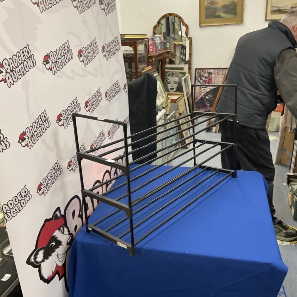 Blue plastic shoe rack for home organization and storage.