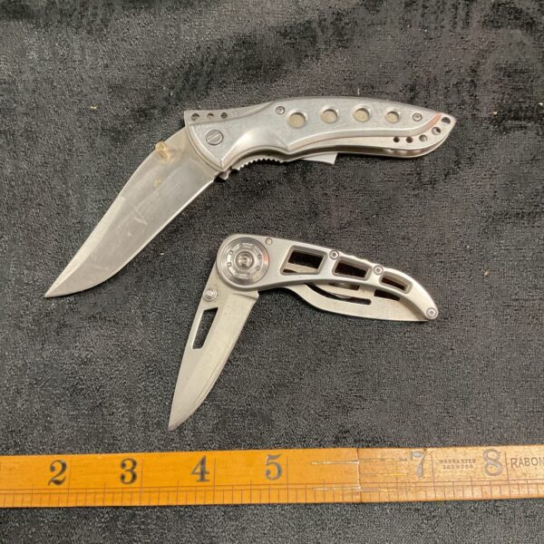 Stainless steel folding pocket knife, potentially Gerber or Whitby.