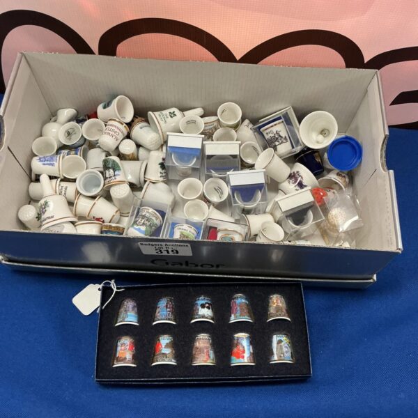 Collection of vintage porcelain thimbles displayed in a lot.