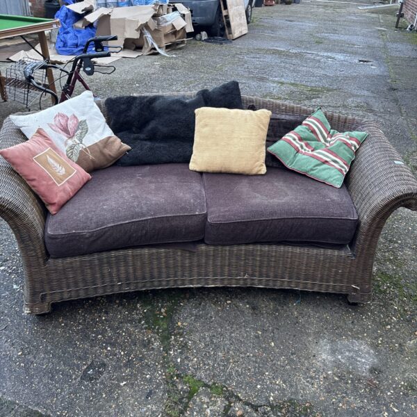 Woven rattan garden sofa for outdoor use.