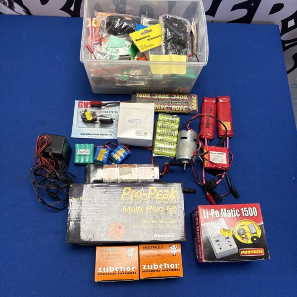 RC model radio parts lot with batteries and wires.