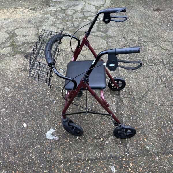 Red walking aid frame with seat and basket for senior mobility.