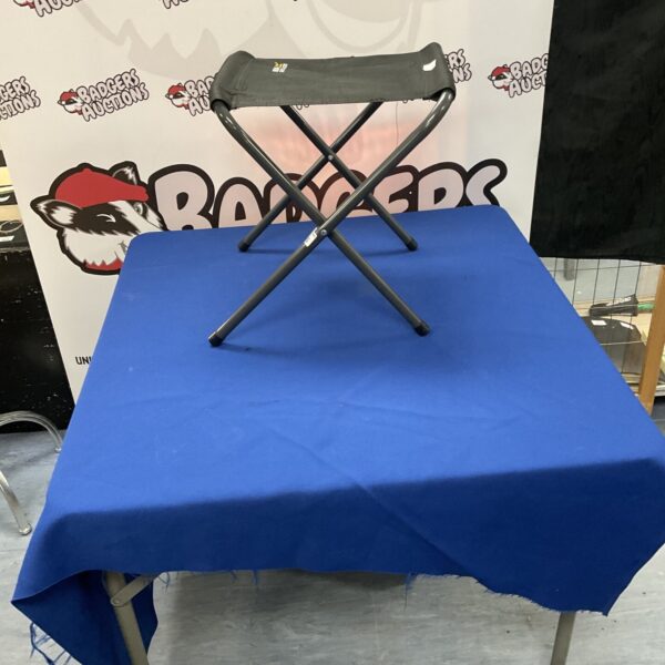 Black and grey Regatta Marcos folding stool for outdoor use.