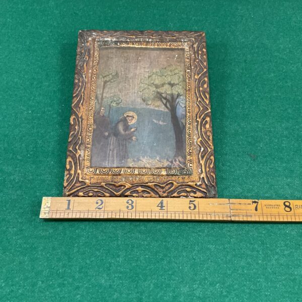 Vintage religious icon print on a wooden panel for devotional display.