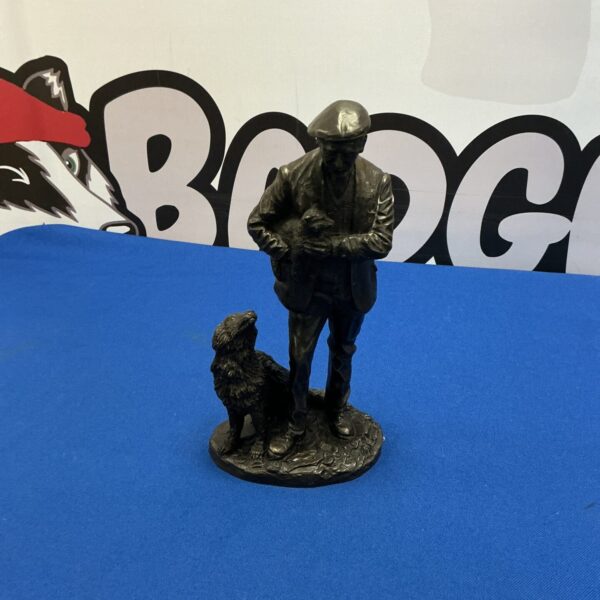 Detailed resin dog figure of man with dogs.