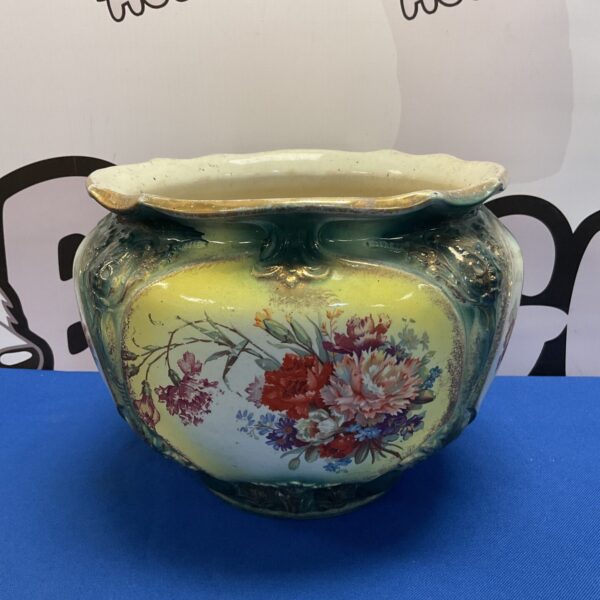 Antique Roosevelt jardiniere with vibrant floral pattern.