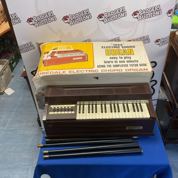 Vintage Rosedale electric chord organ in woodgrain finish.