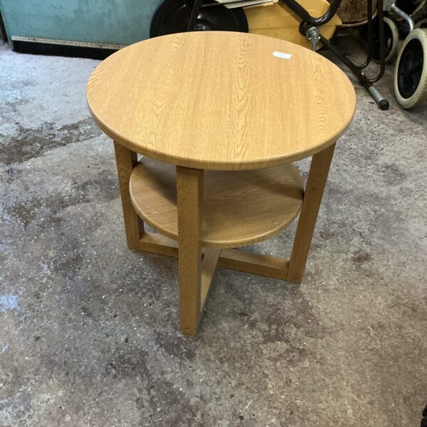 Small round oak effect side table with shelf.
