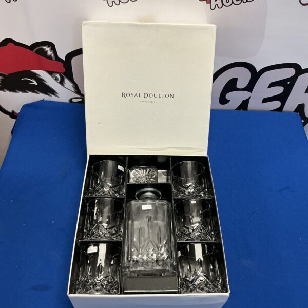 Royal Doulton whiskey decanter set with six tumblers on display.