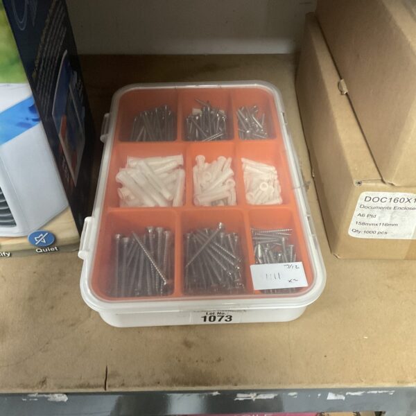 Plastic organiser tray filled with screws and rawl plugs for DIY projects.