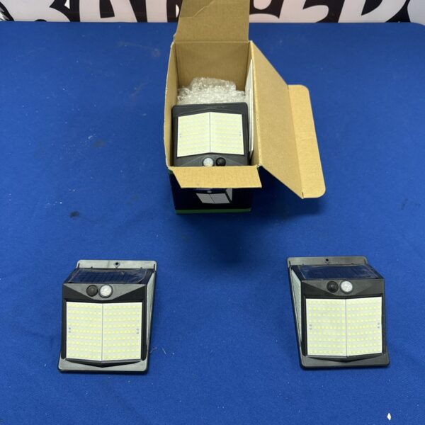 Selkin solar powered flood lights in original packaging.