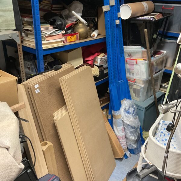 Metal shed shelving system with storage boxes.