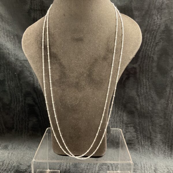 Pair of delicate 925 silver ball chain necklaces on display.