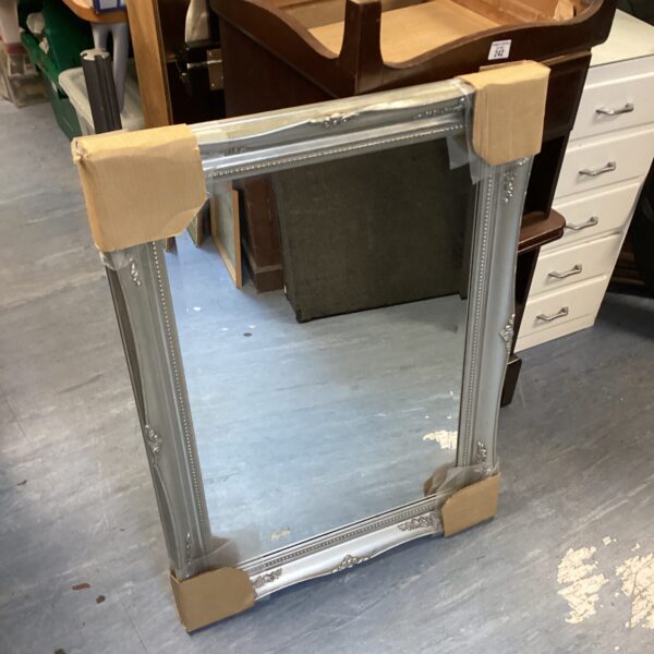 Ornate silver effect decorative wall mirror for home decor.