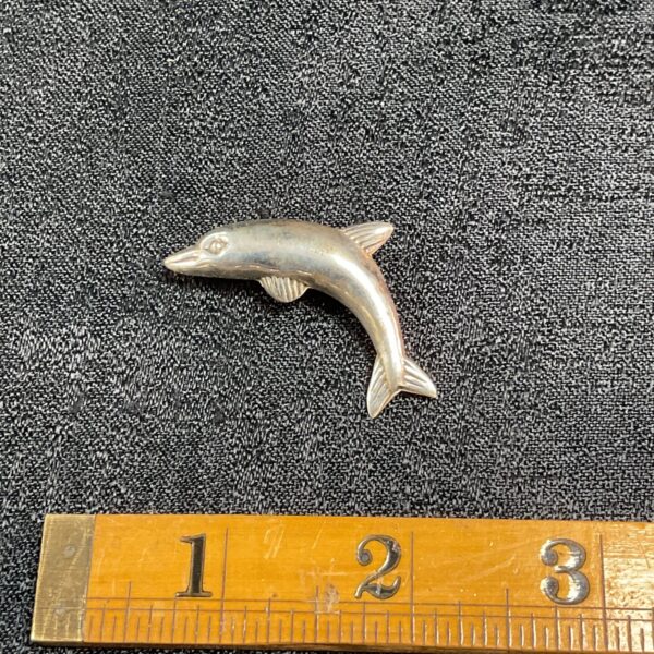 Vintage silver dolphin brooch, detailed animal jewellery.