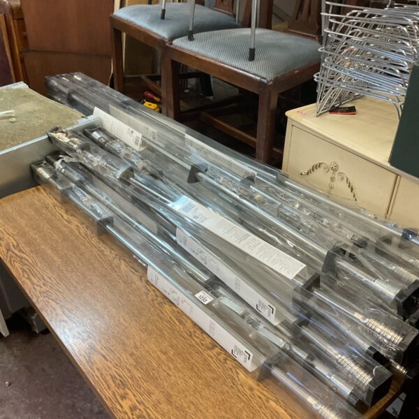 Large lot of silver extendable curtain poles for window treatments.