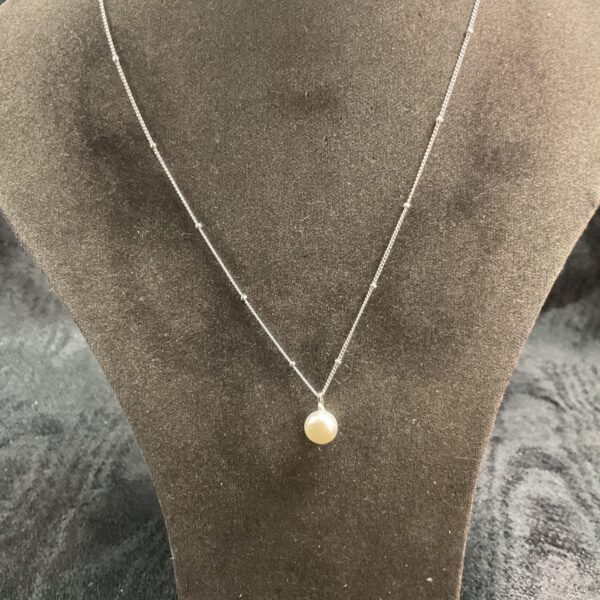 Delicate silver pearl necklace with a classic pendant.