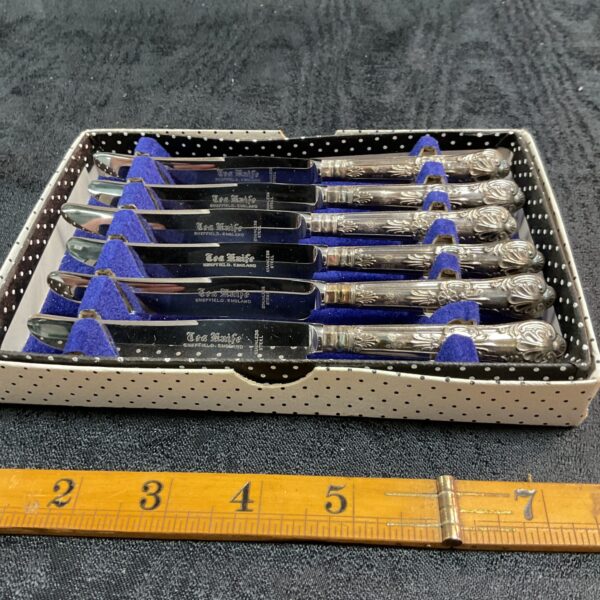Vintage silver handled tea knives in a velvet lined box.
