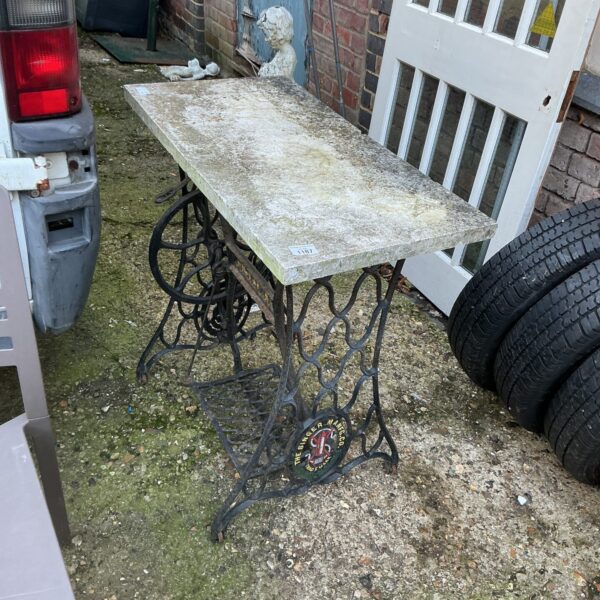 Vintage Singer garden table with tiled top and cast iron base.