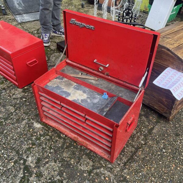 Red Snap On tool box with drilled lock, ideal for mechanics.