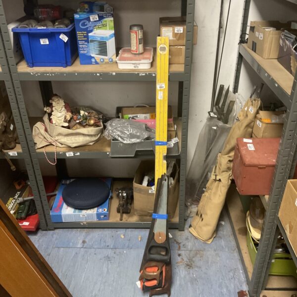 Vintage spirit level and hand saws lot for woodworking projects.