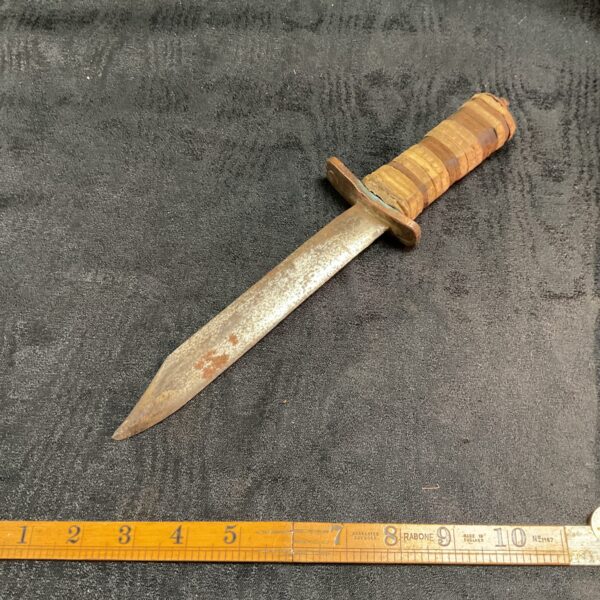 Handmade stack leather knife with unfinished blade and handle.